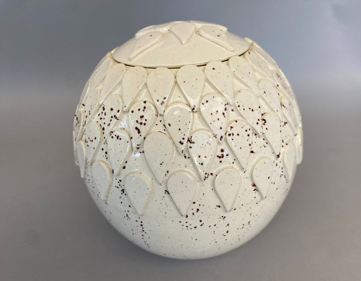 Handmade lidded jar in Dragon tooth design